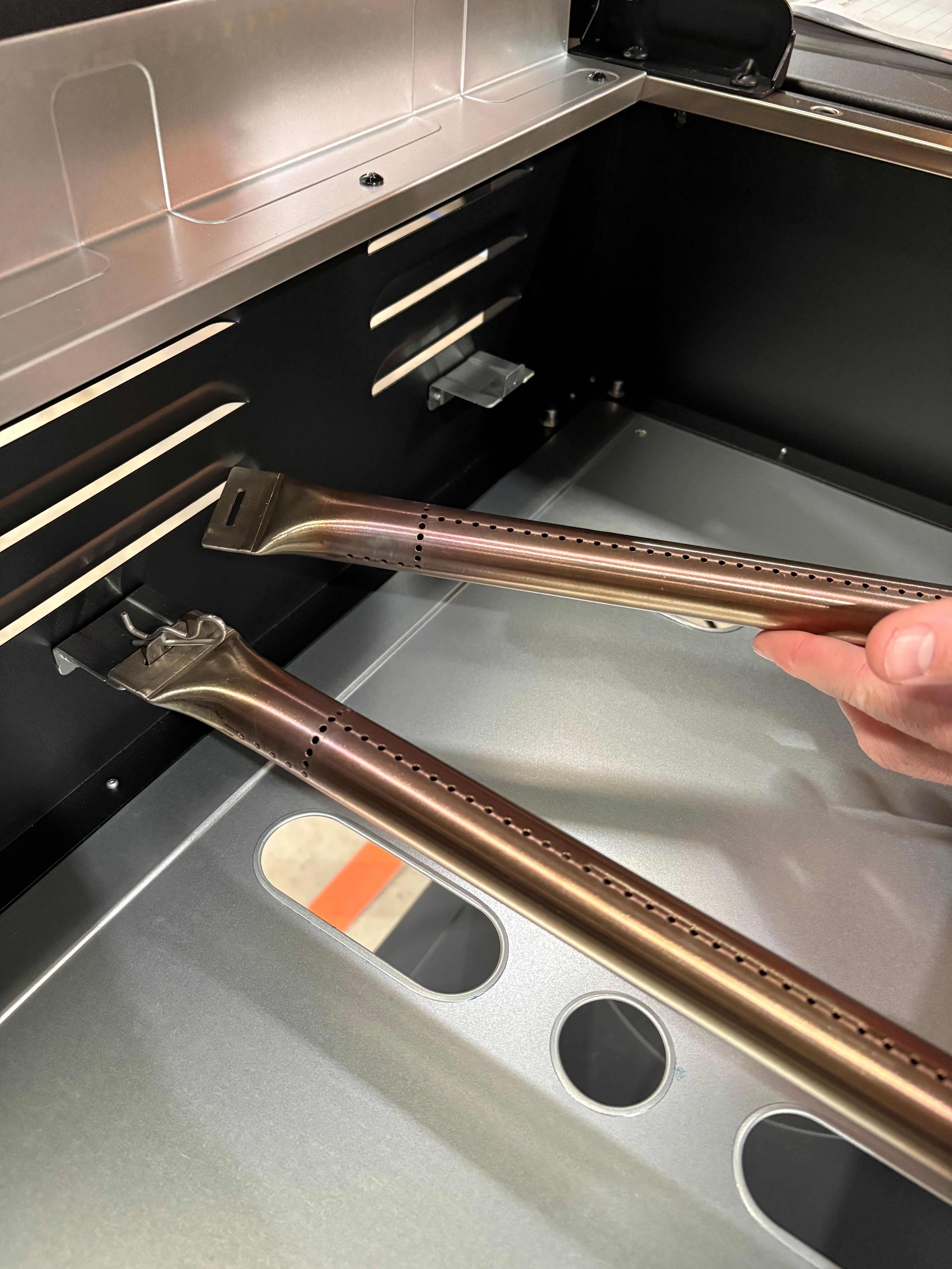 Image showing the removal of the burner of a 4-burner grill.