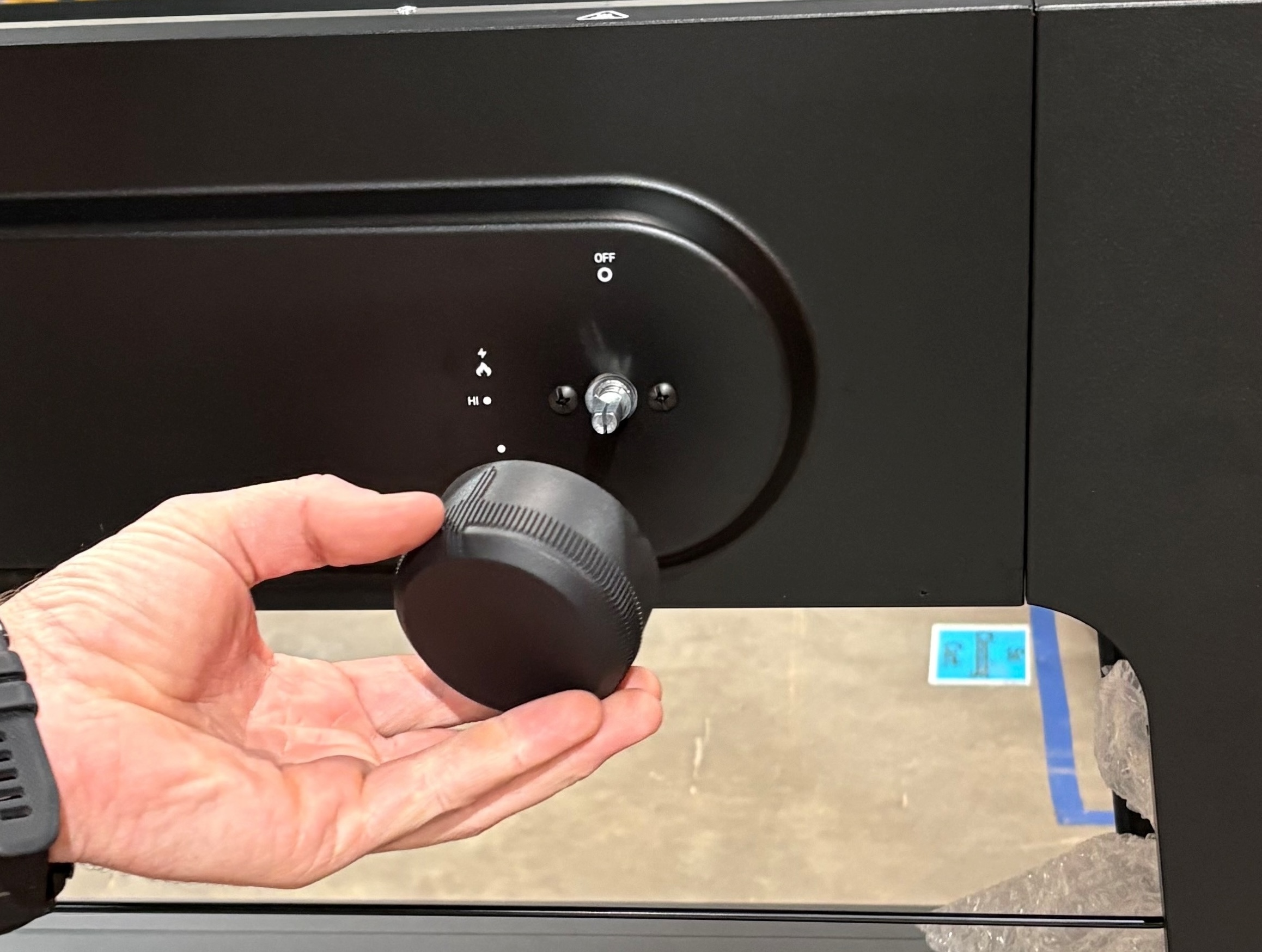 Image of burner knob being removed.