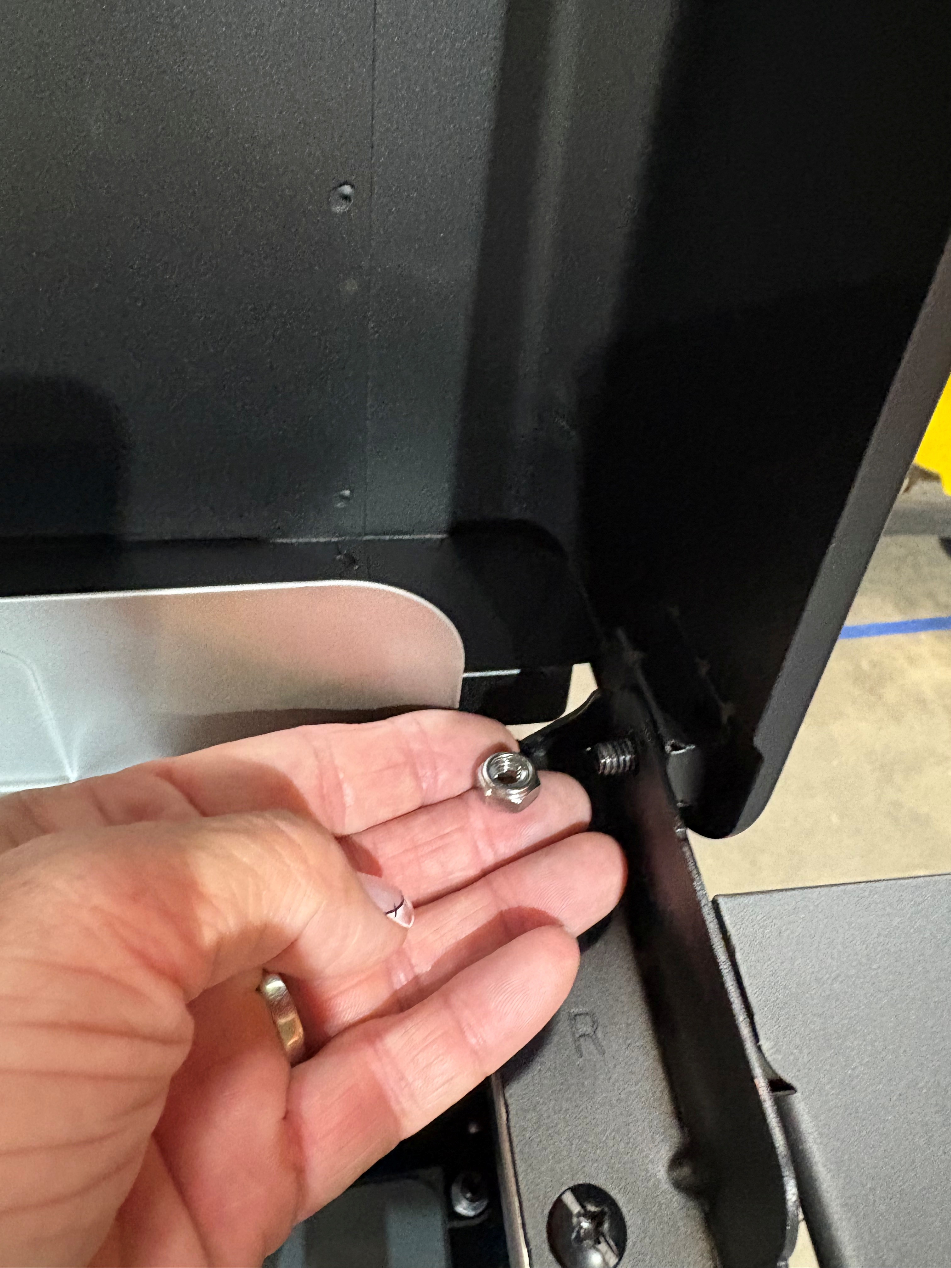 Image of nut that needs to be removed from the lid. 