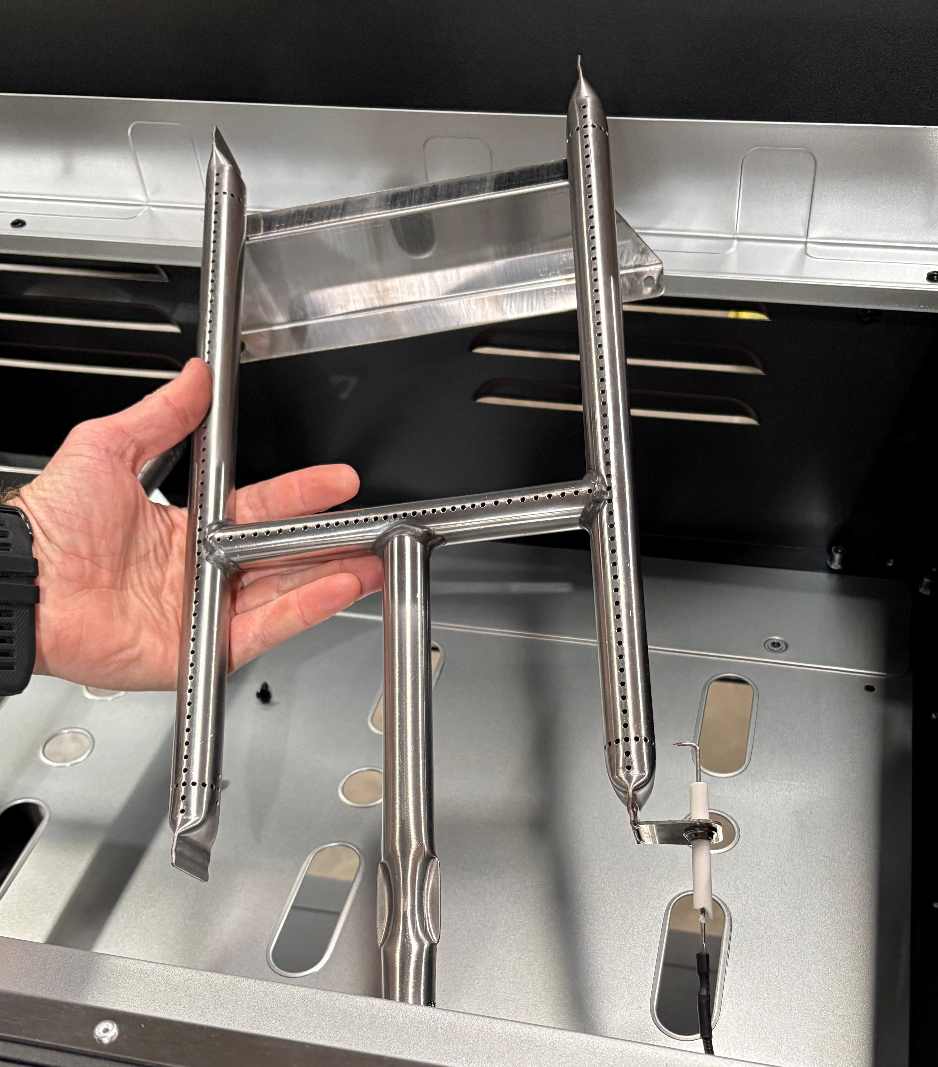Image of H-burner being removed from griddle.