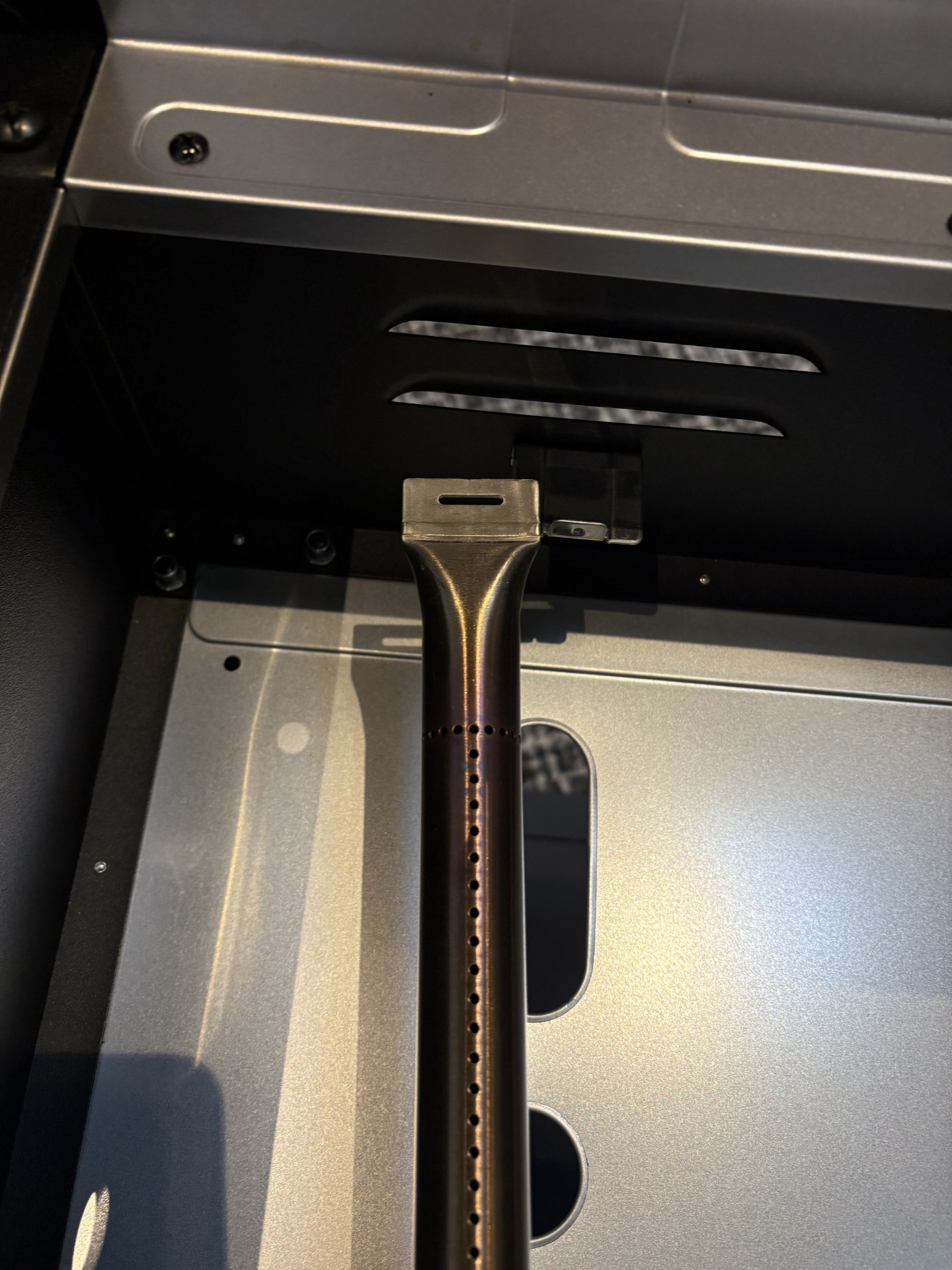 Image of stick burner being removed from the griddle.