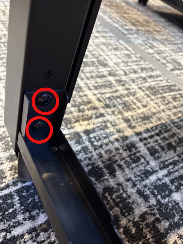 Image showing two red circles outlining screws that need to be removed. 