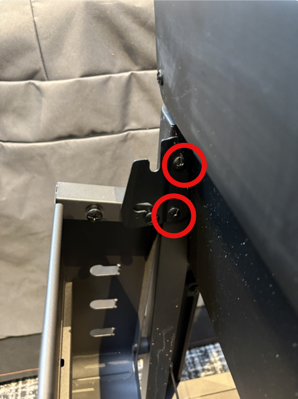 Image showing two red circles showing the screws that need to be removed 