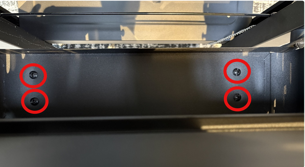 Image showing 4 red circles outlining the screws that need to be removed. 
