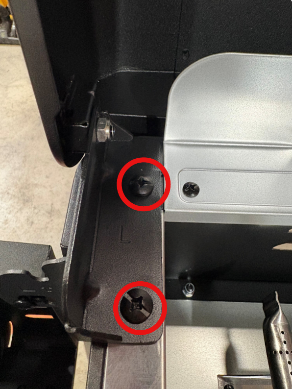 Image showing two red circles outlining the screws that need to be removed.